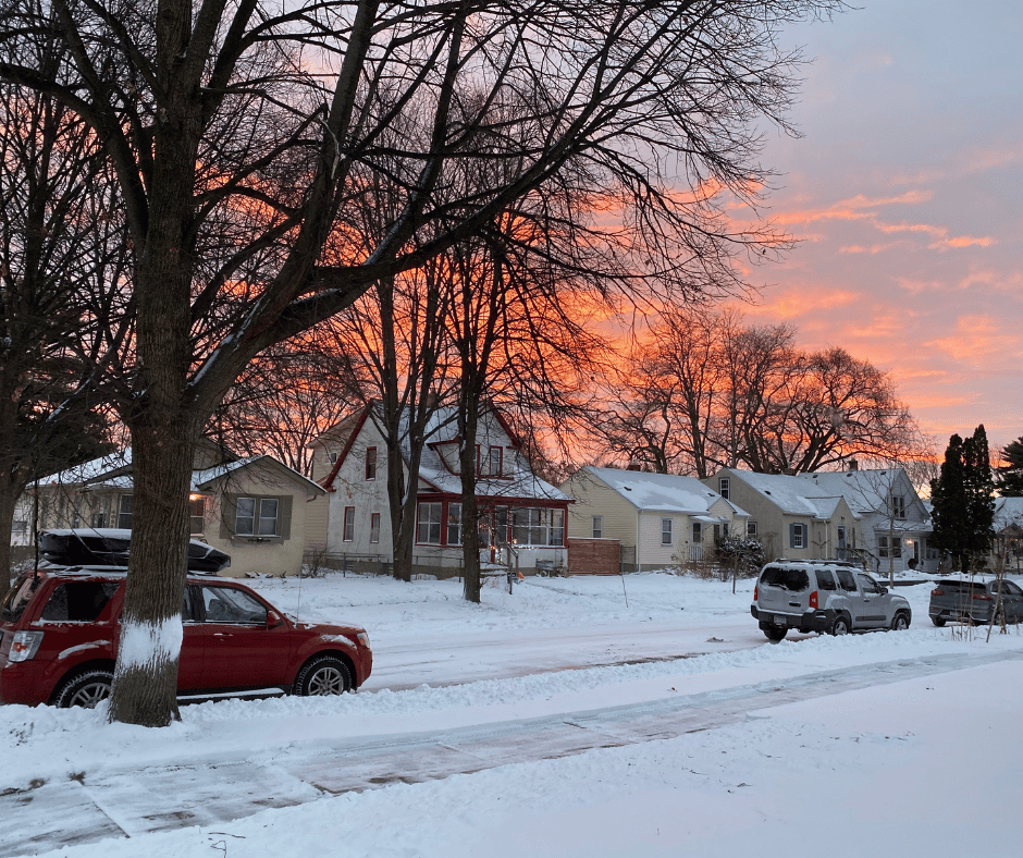 Kristina's neighborhood street with snow in the evening as the sun is setting